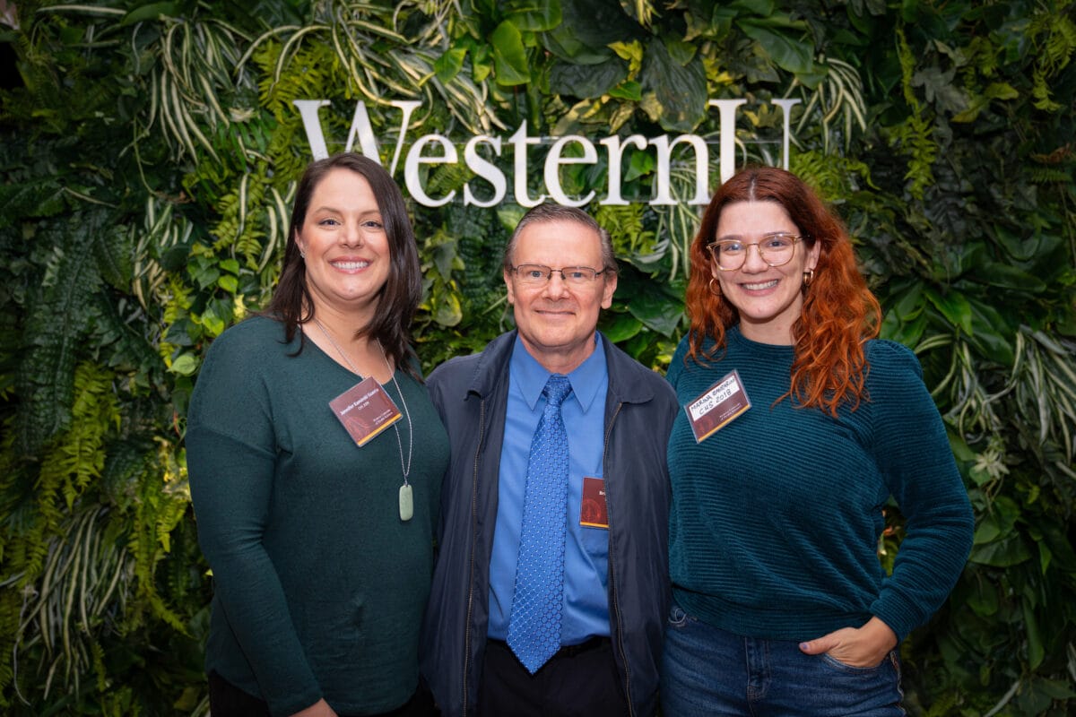 Three people posing for photo