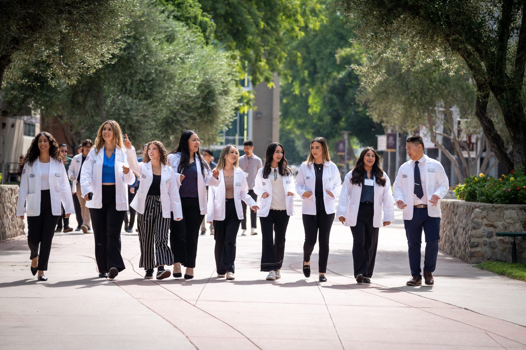 Group of students in white coats walking