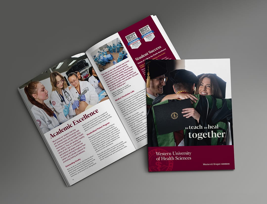 Two university brochures are displayed; one is open showing students in lab coats, while the other is closed featuring graduates hugging and holding a diploma.