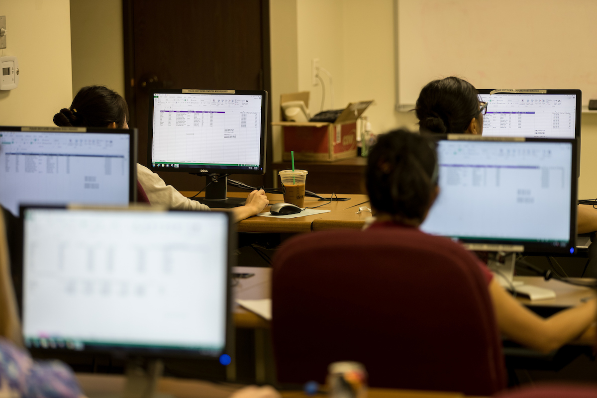 Students working on computers in a classroom.