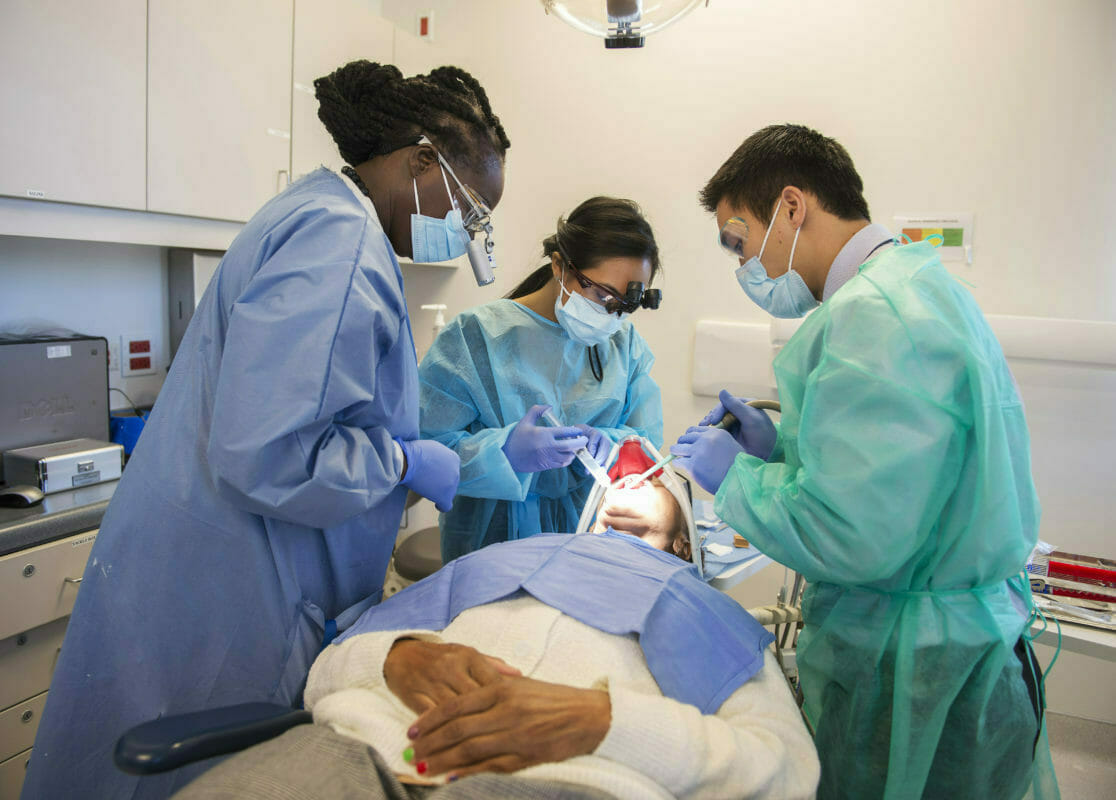 Three students with dental patient