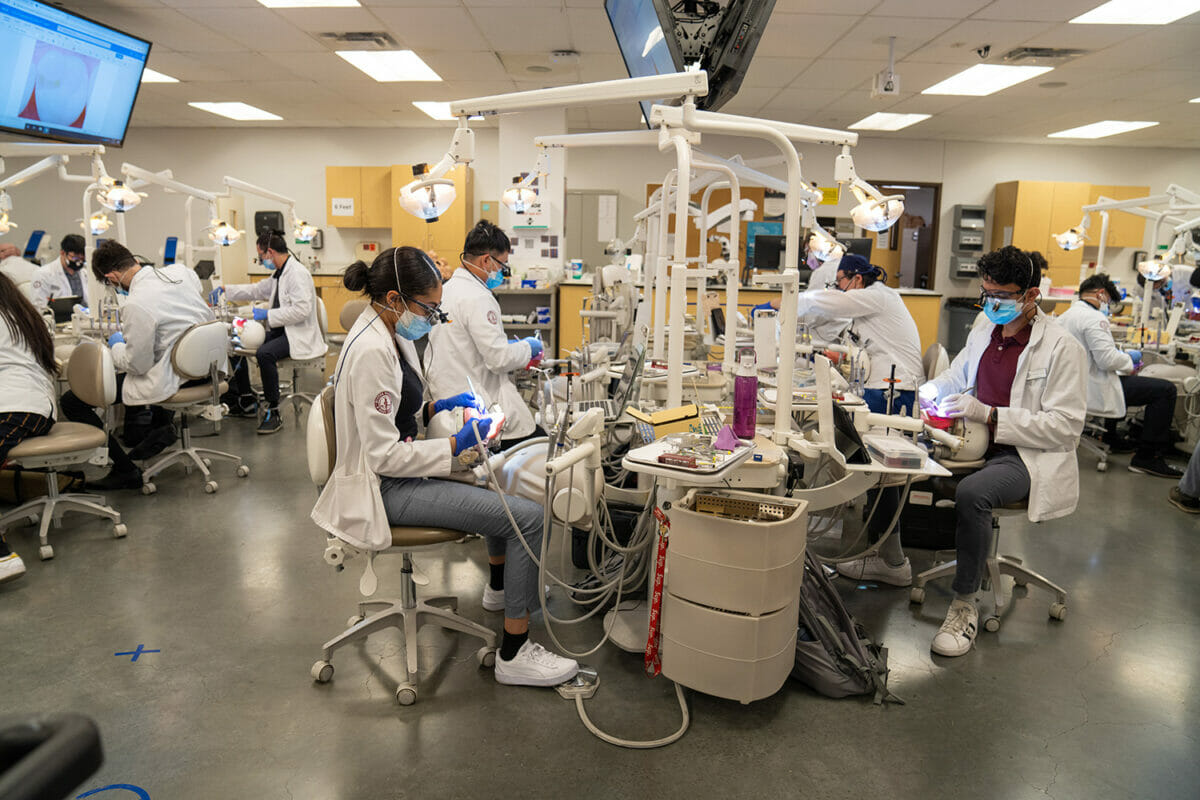 Students working with dental technology in SIM lab