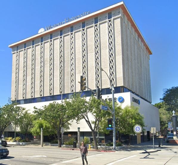 a google street view of a large building on a corner.