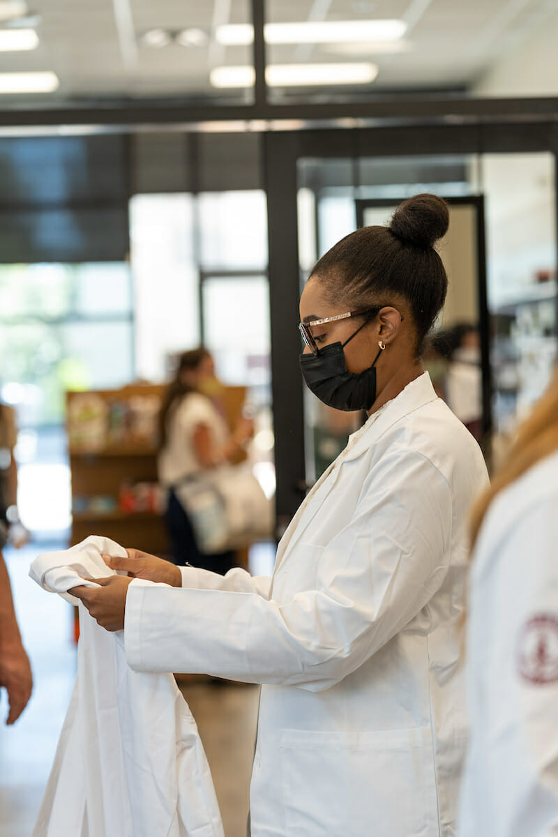 College of Graduate Nursing MSN-E incoming students try on and receive their white coats during WesternU Welcome Week