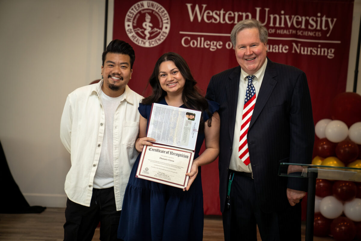 A group of people posing for a photo with a certificate.