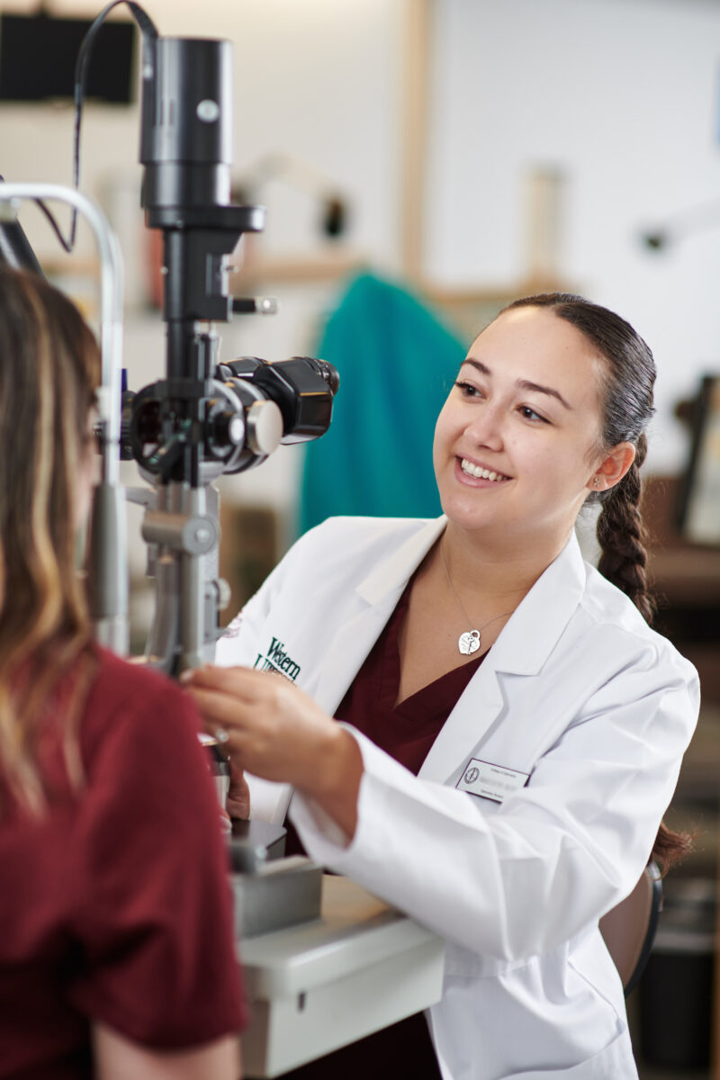 A female doctor is examining a patient's eye.