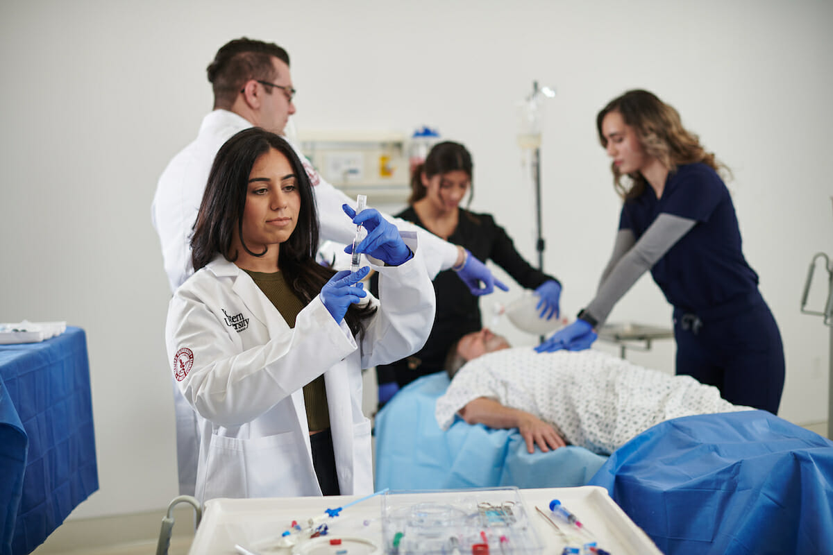 A group of people working on a patient in a hospital.