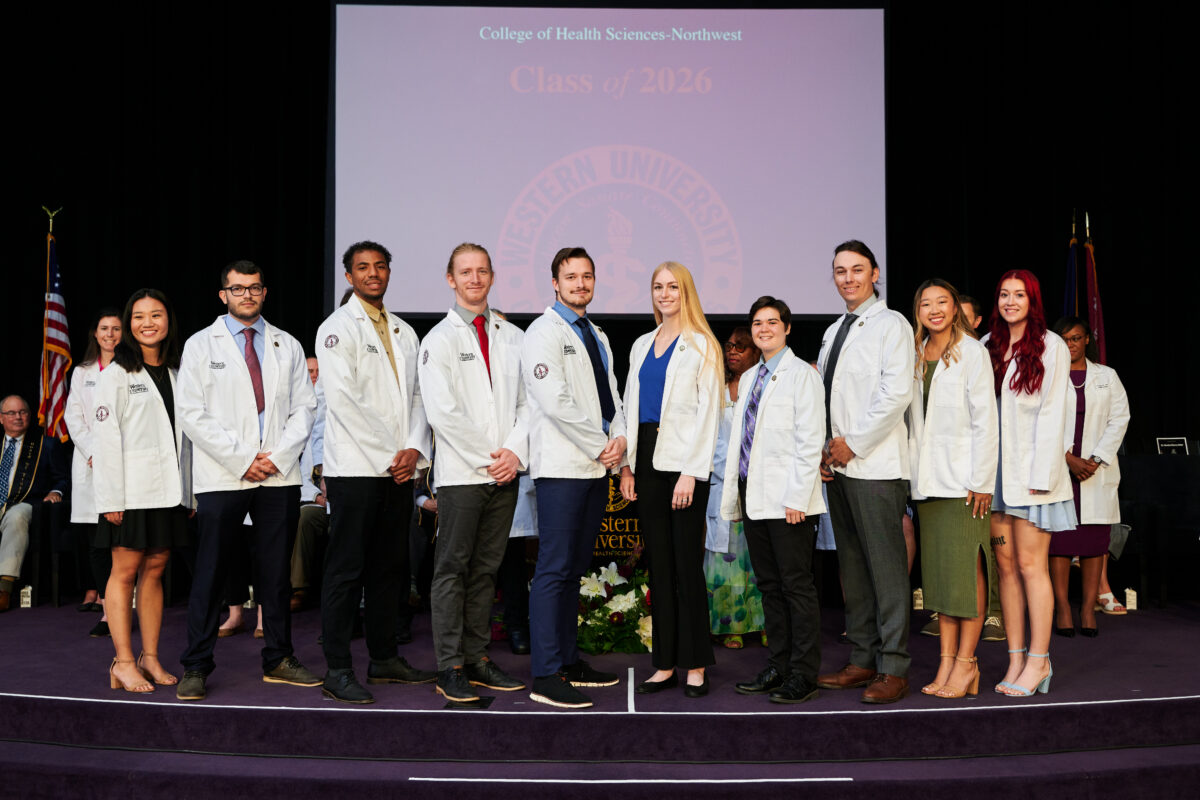 A group of people in lab coats posing for a photo.
