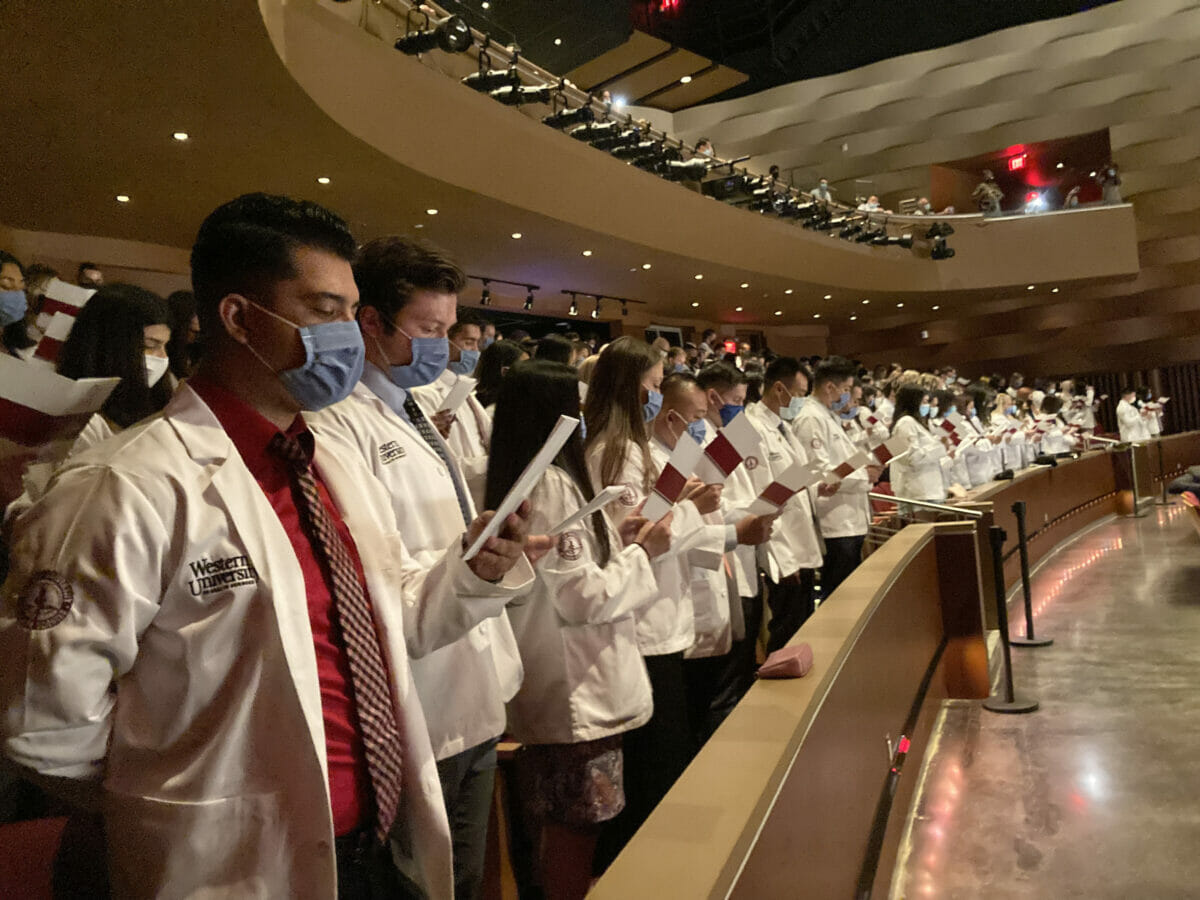 Rows of students in white coats during the white coat ceremony