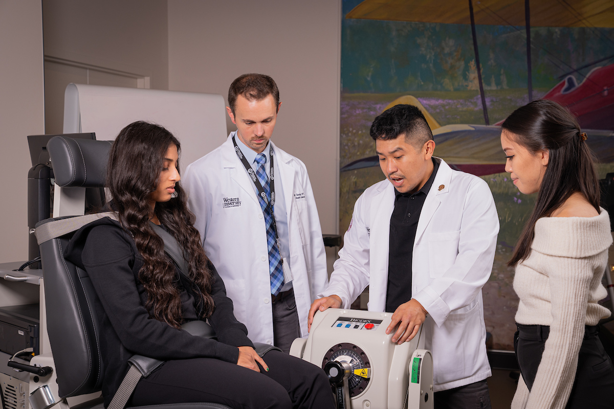 A group of people sitting in a chair with a doctor.