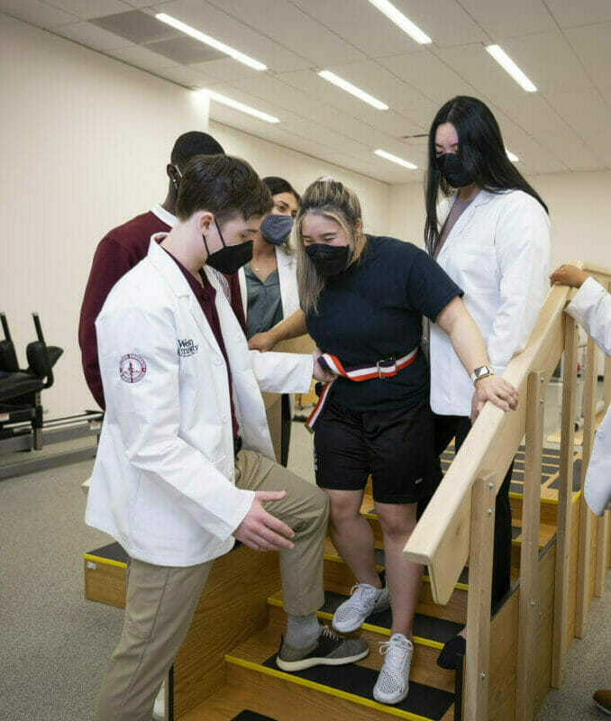 a group of people standing on top of a set of stairs.