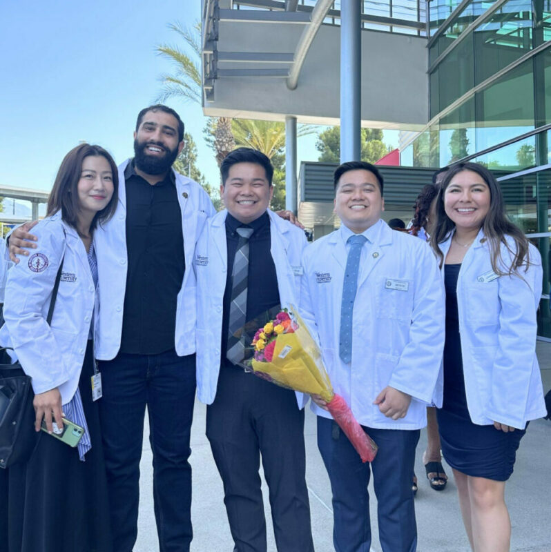 A group of people in lab coats posing for a photo.
