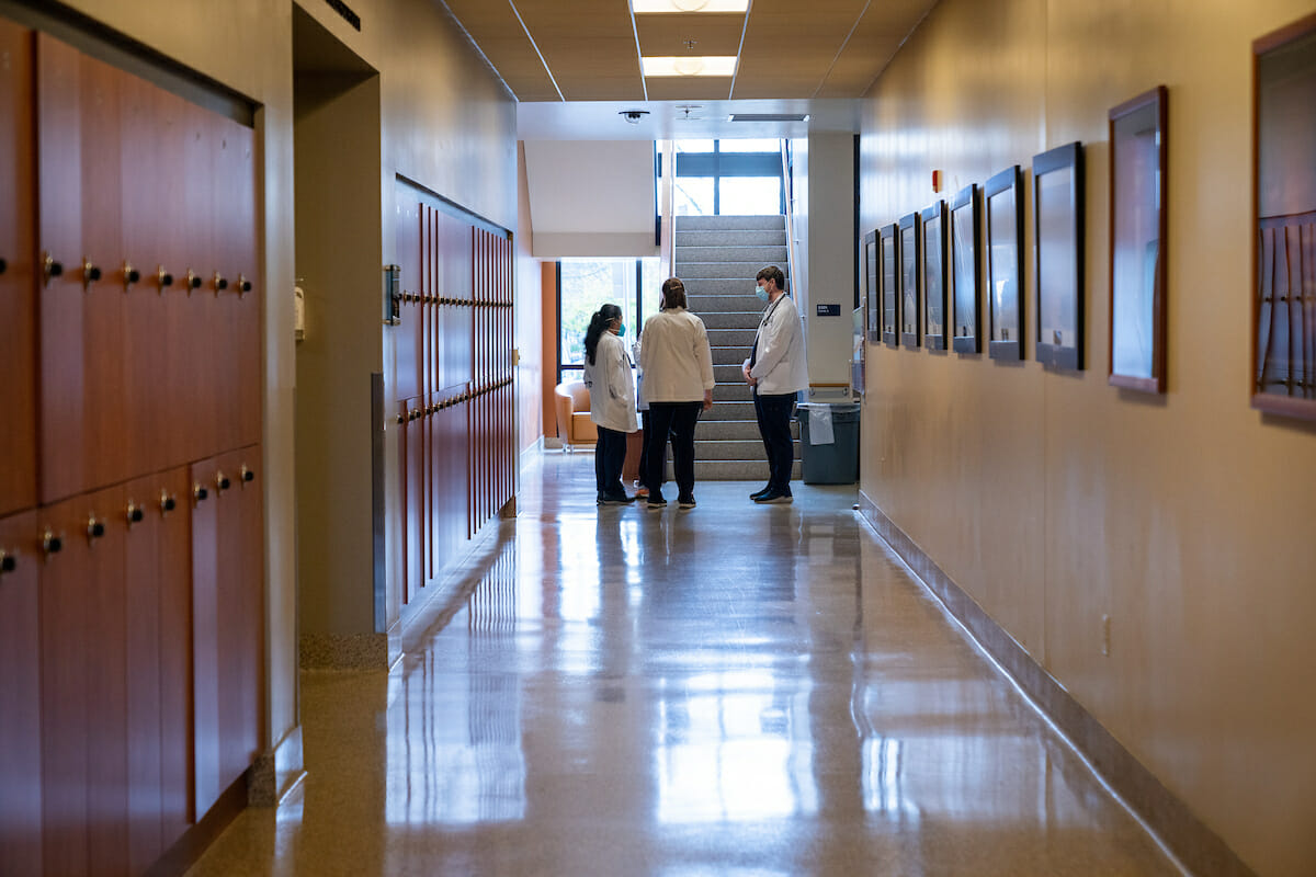 Students Phillip Scott, Sarah Rau and Michelle Riedel chat in the hallway at WesternU COMP-Northwest in Lebanon