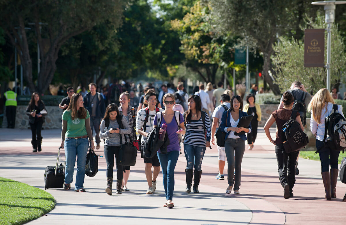 Students and staff walk to or from the Health Education Center on the WesternU campus Esplanade.