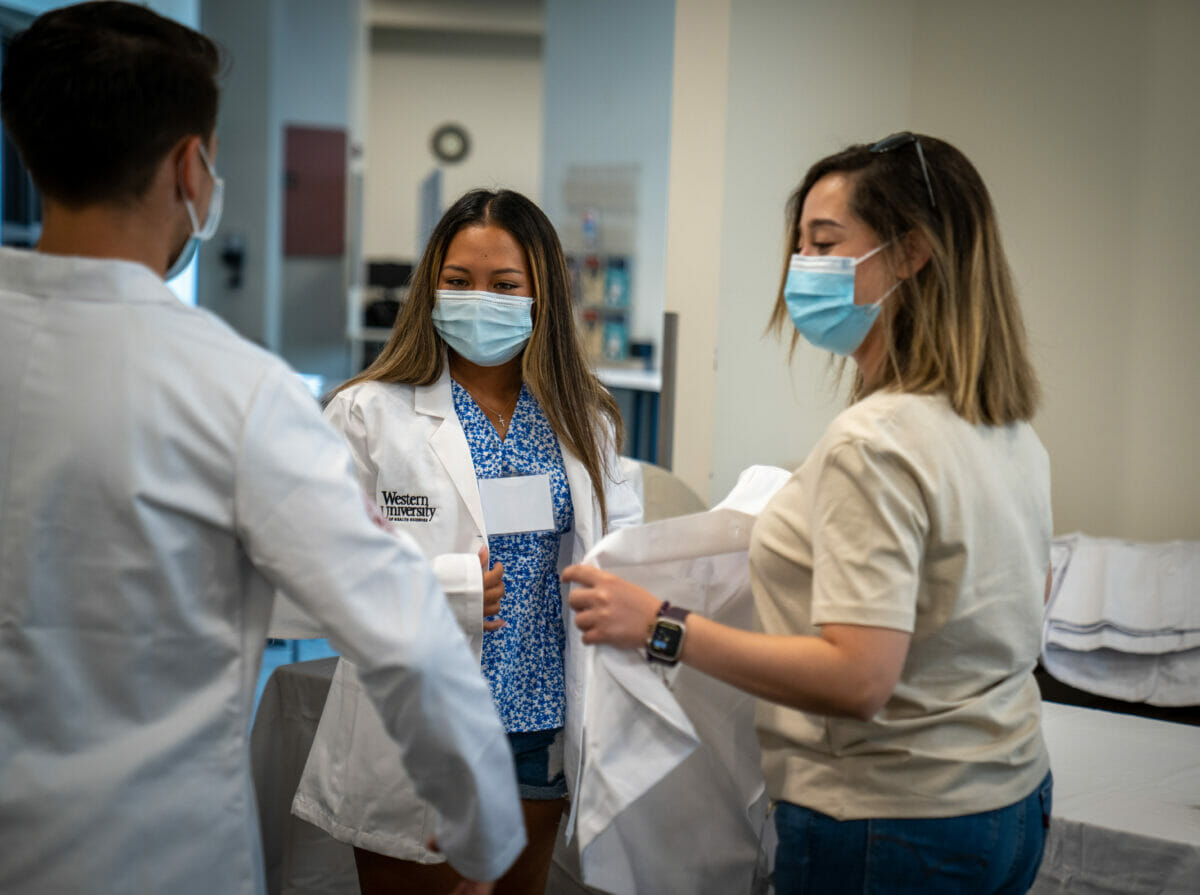 A group of people wearing face masks in a lab.
