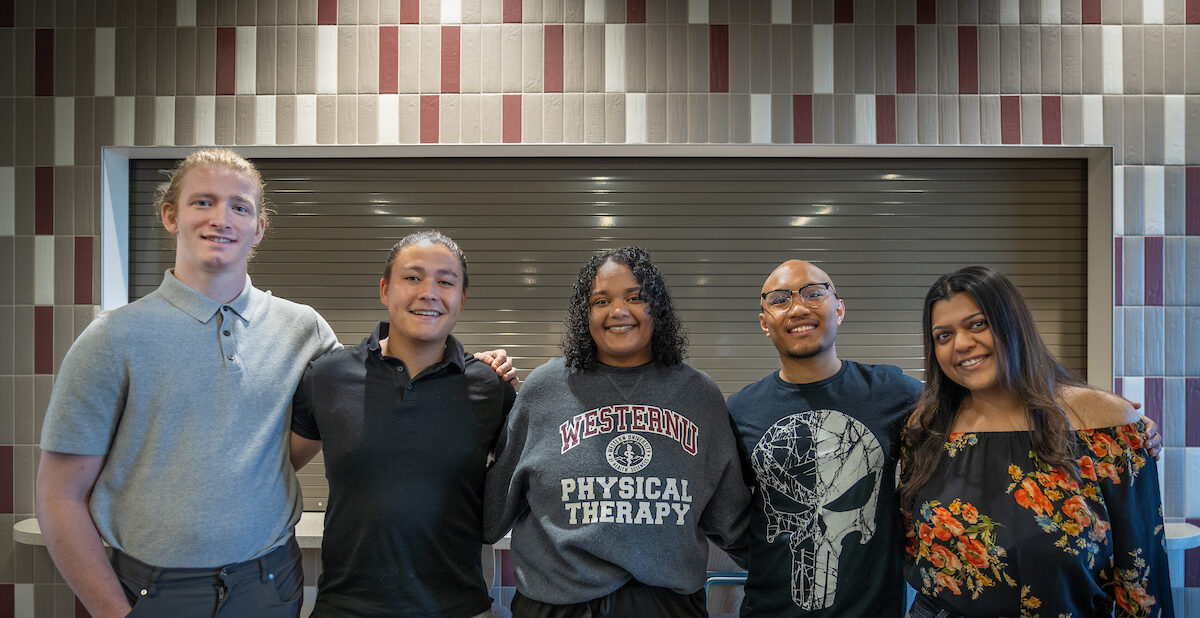 A group of people posing for a photo in a library.