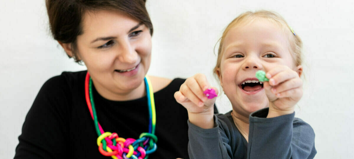 Therapist with Child holding toys