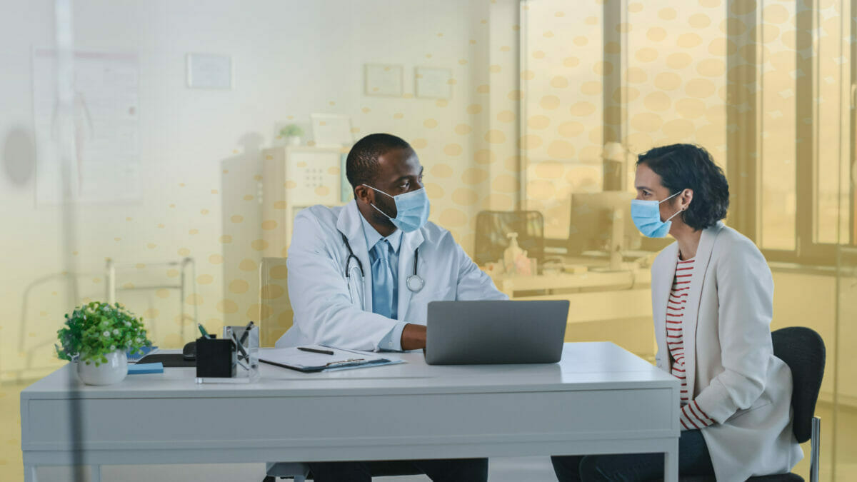 Doctor and patient at desk talking