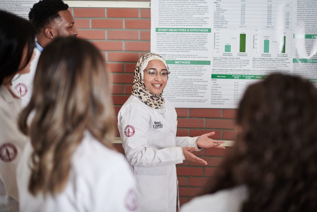 Female student presenting a poster presenation.