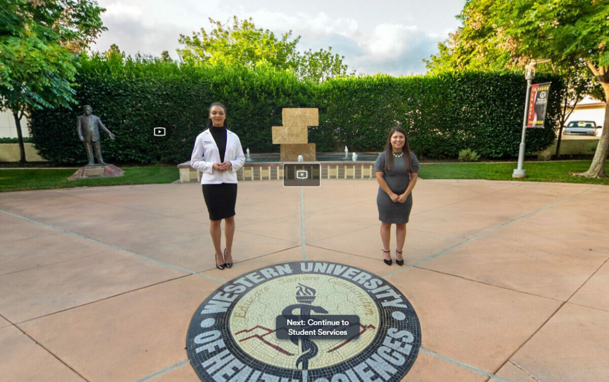Virtual tour hosts standing in front of fountain