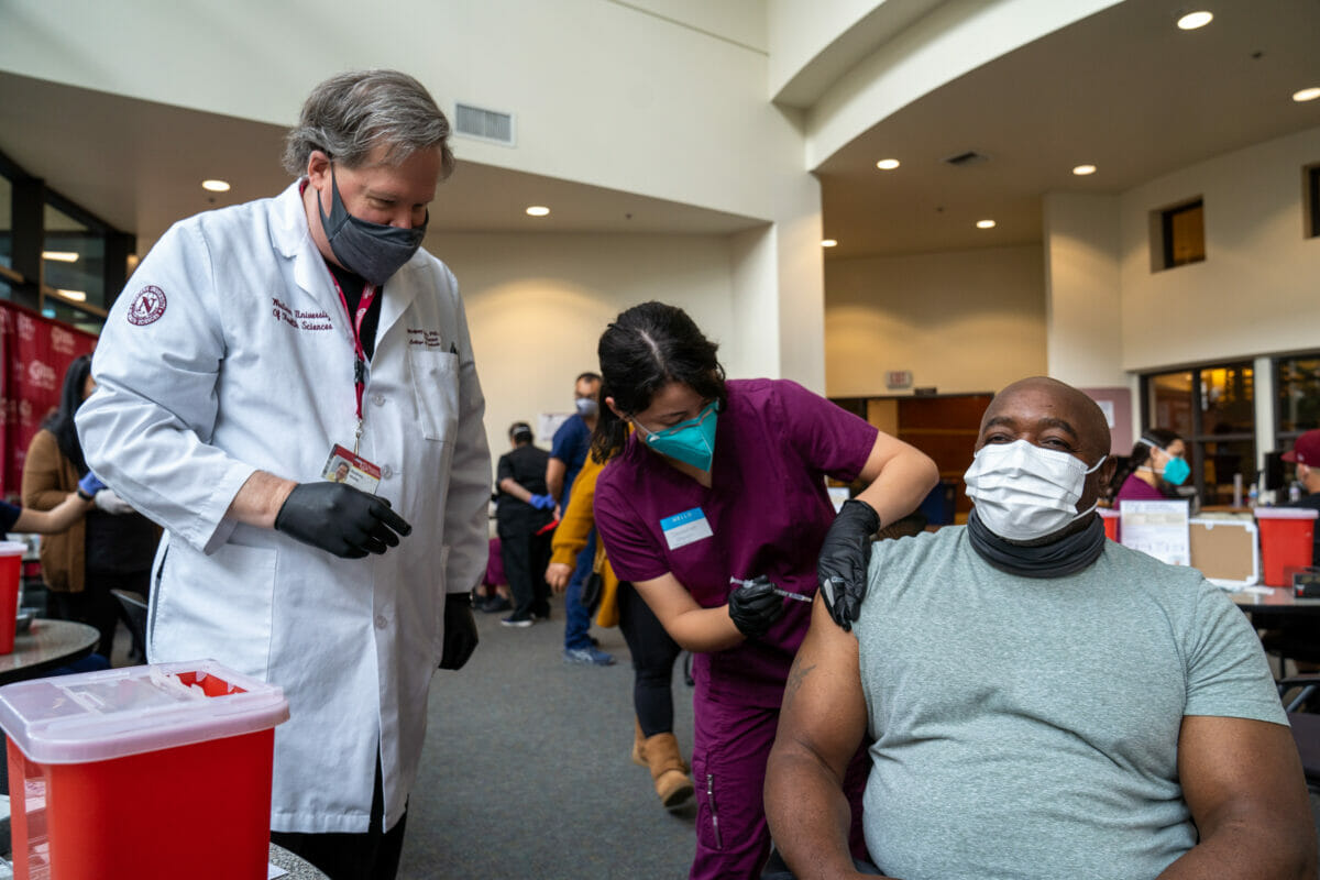 COVID-19 Vaccine Clinic, faculty member observing student in vaccination clinic