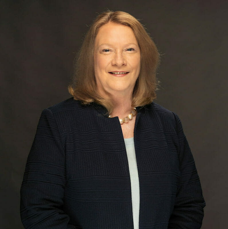 College of Graduate Nursing Dean Mary Lopez, Phd, RN, in navy blue blazer with white blouse