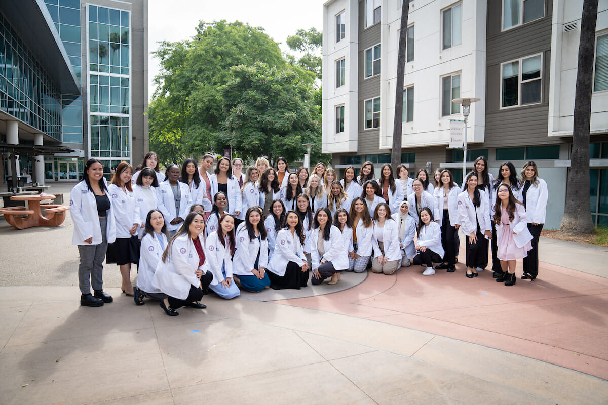 Group, women, white lab coats, photo.