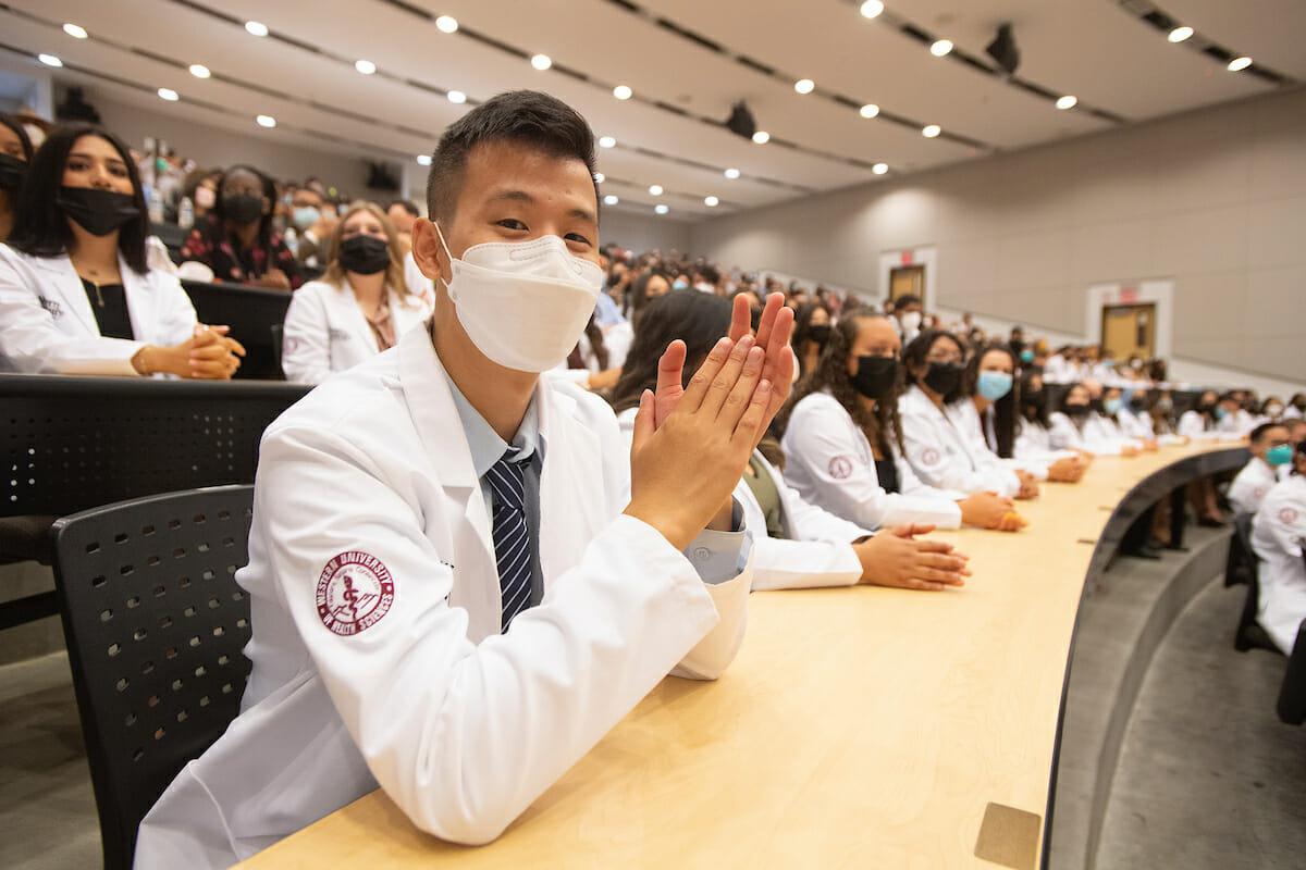 Students in white coats in classroom