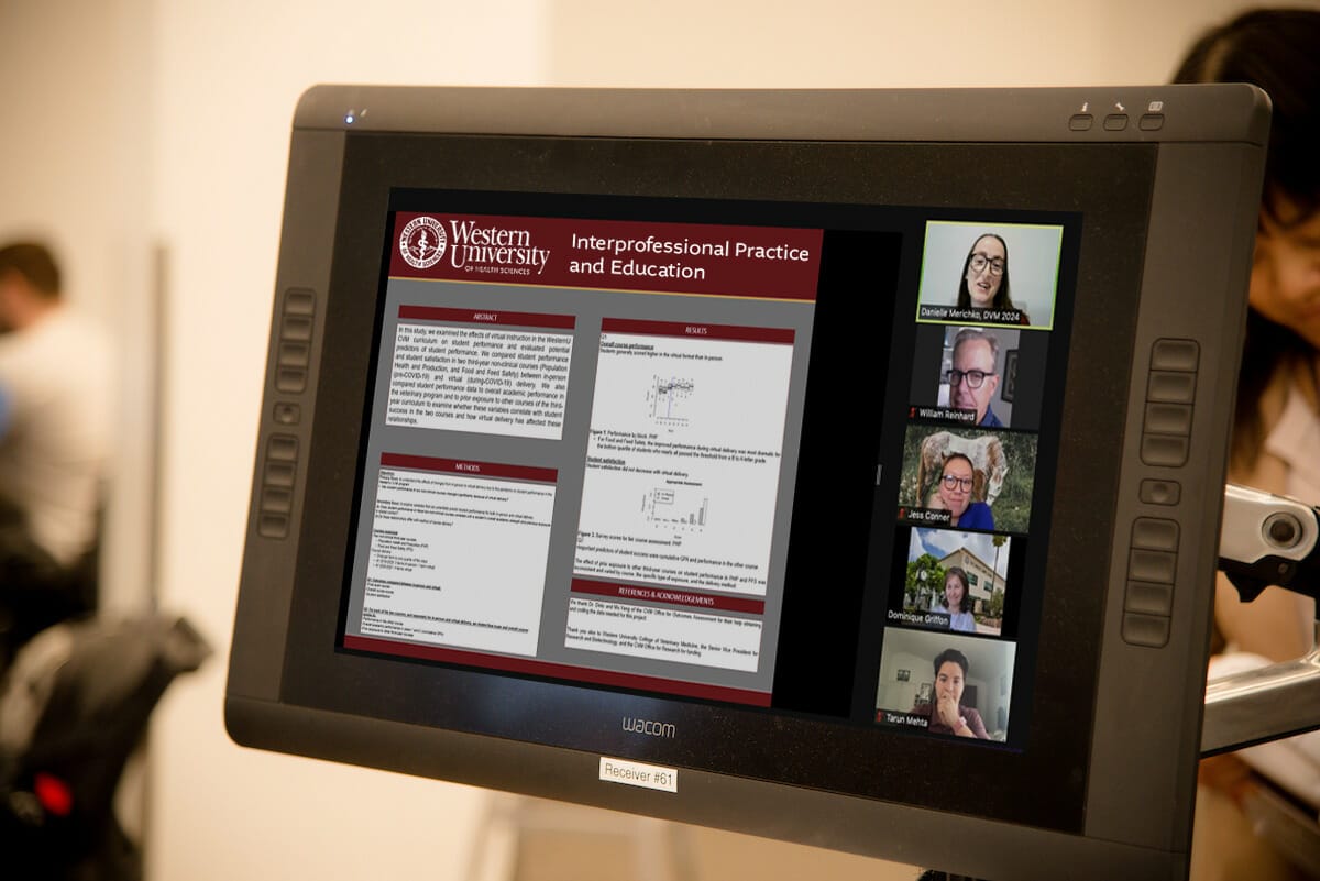 A touchscreen display shows an academic presentation titled "Interprofessional Practice and Education" with participants attending virtually via a video call.