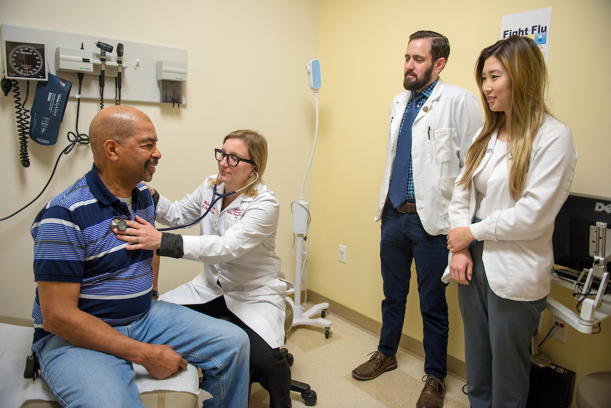 A man is being examined by a doctor in a hospital.