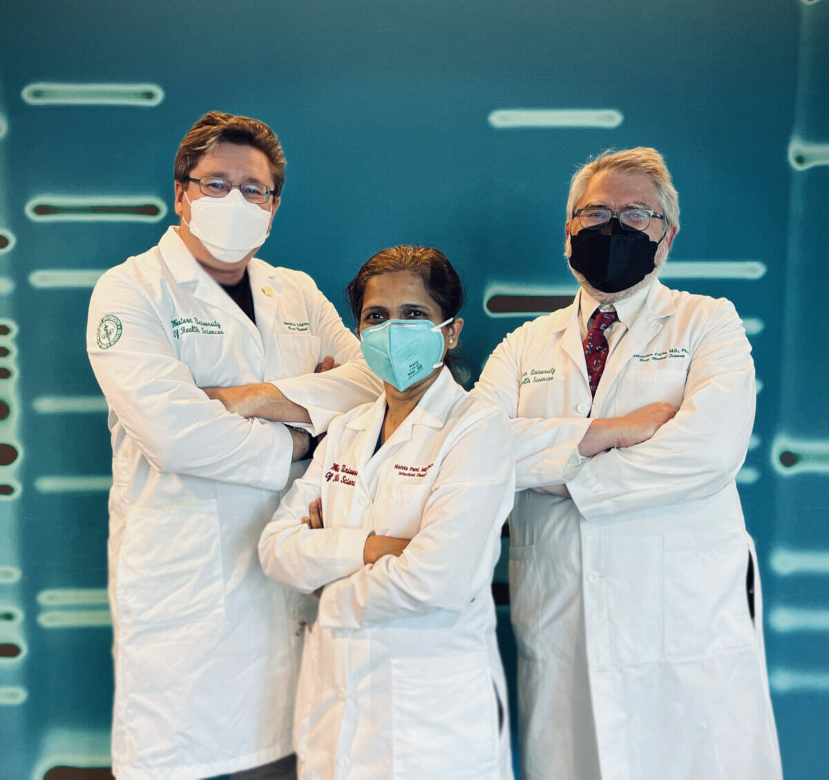 image of crt-team, 3 doctors in white coats and masks standing, with arms crossed