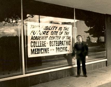 Scan of original print, Dr. Phillip Pumerantz in front of the site of the original College of Osteopathic Medicine of the Pacific, 309 E. Second St. Pomona, Ca. circa 1977.