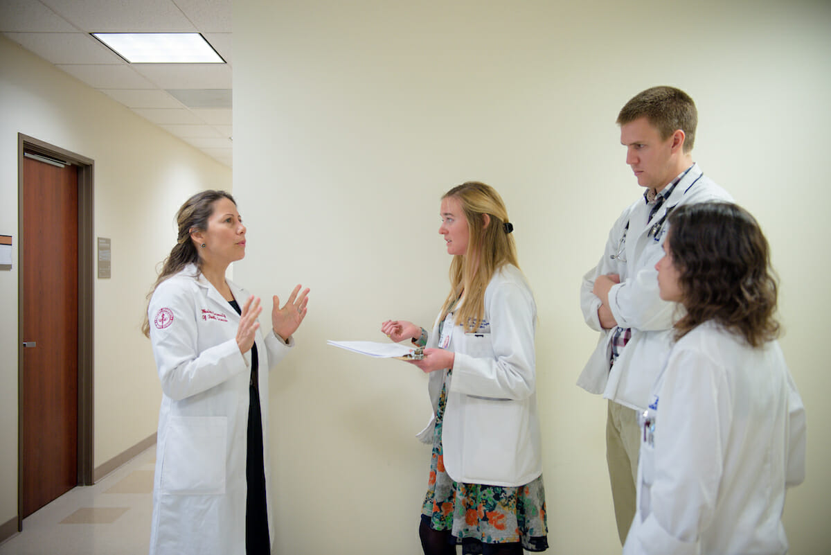 COMP Assistant Professor and Chair for the Department of Pediatrics Lisa Warren, DO '01, discusses a patient with COMP student Cassie Stegall with fellow classmates Garrett Suchecki abd Darina Dinov at the Medical Center at WesternU.