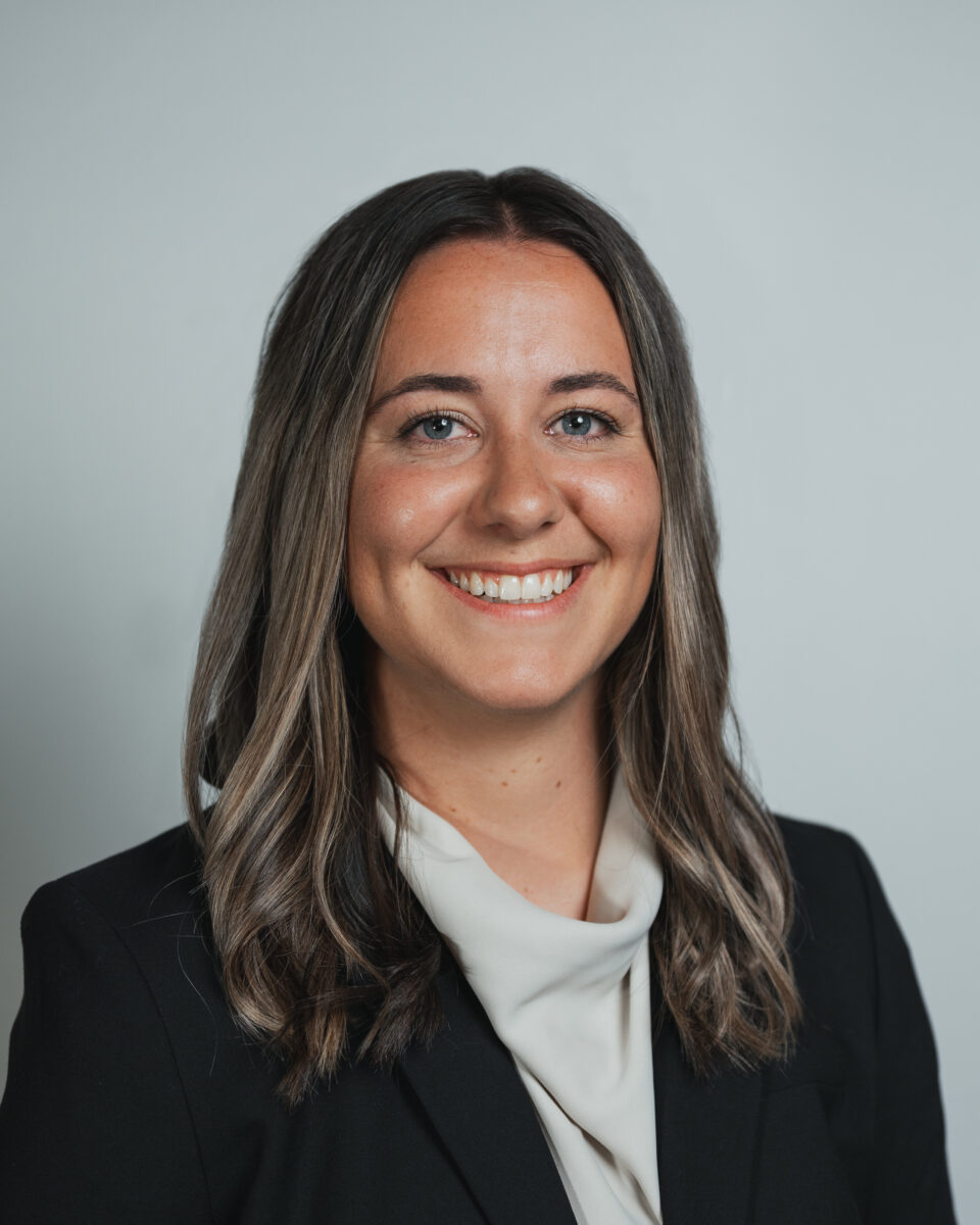 A smiling woman in a business suit.