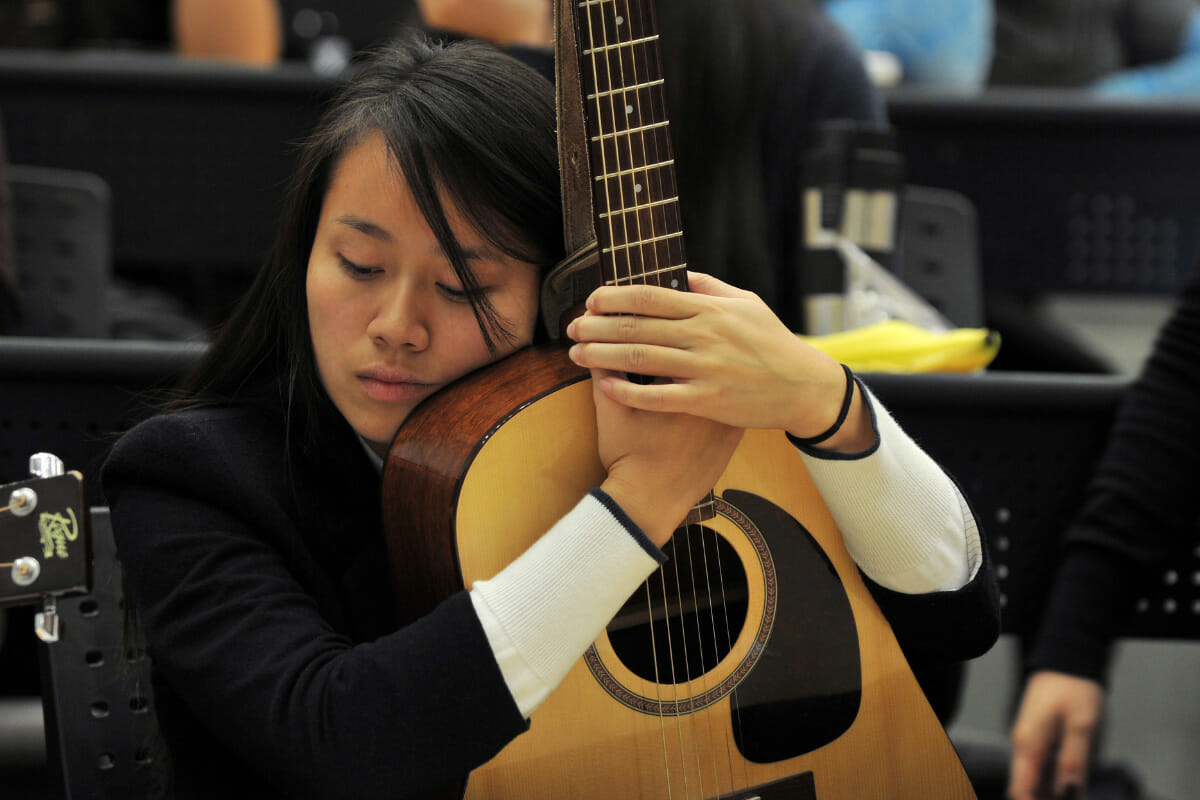 woman holding guitar