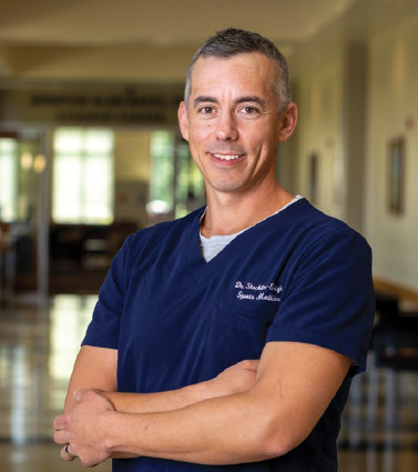 man, blue scrub shirt, hallway
