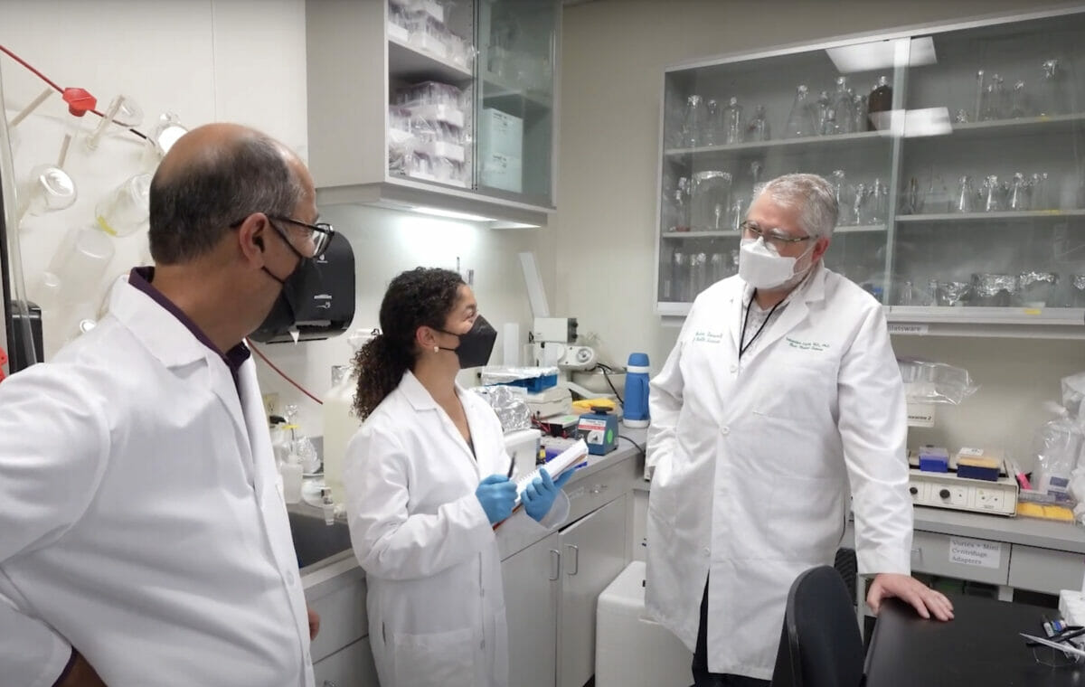 Student with faculty in laboratory