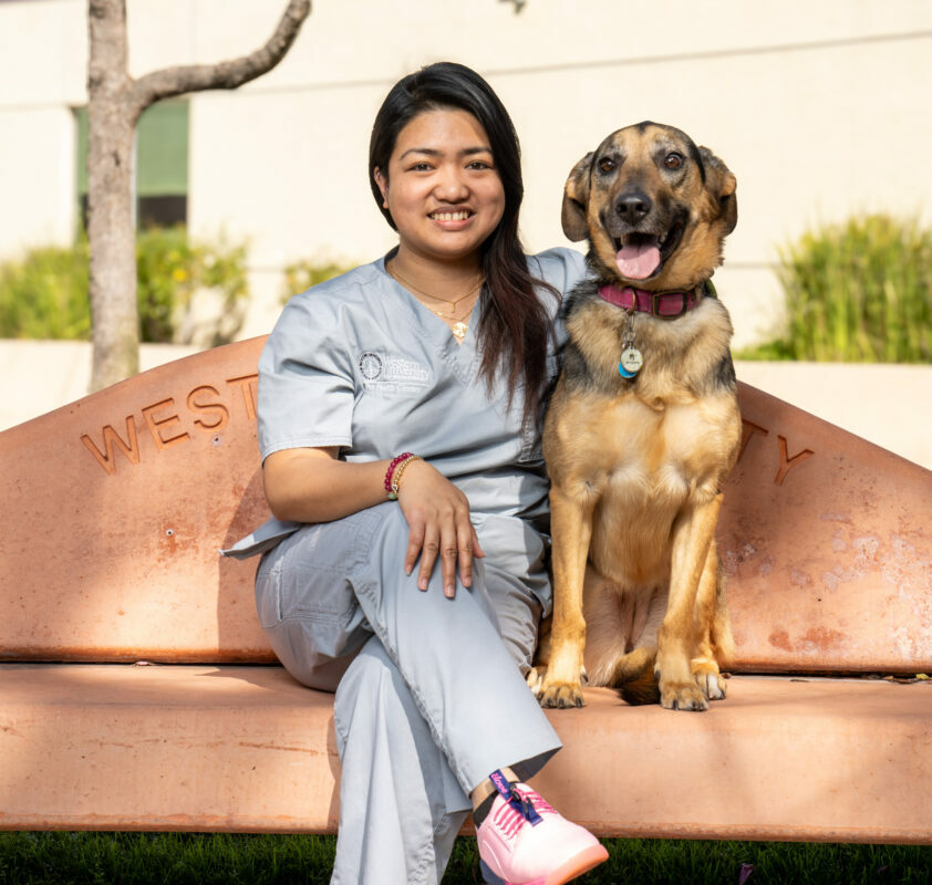 WesternU PHC staff member Jan Neill Sabado Bean on a bench with her dog
