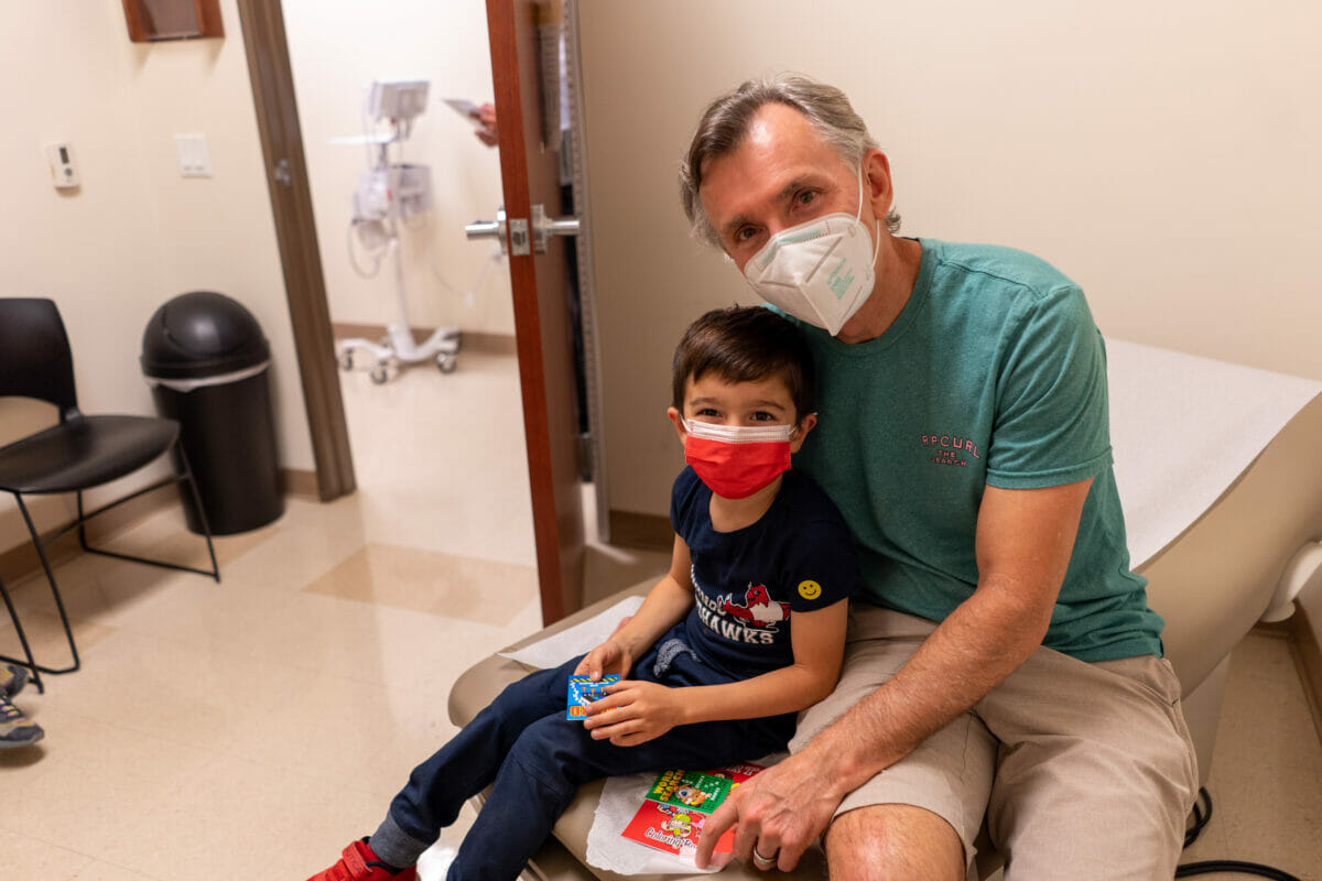 Man with child in medical exam room