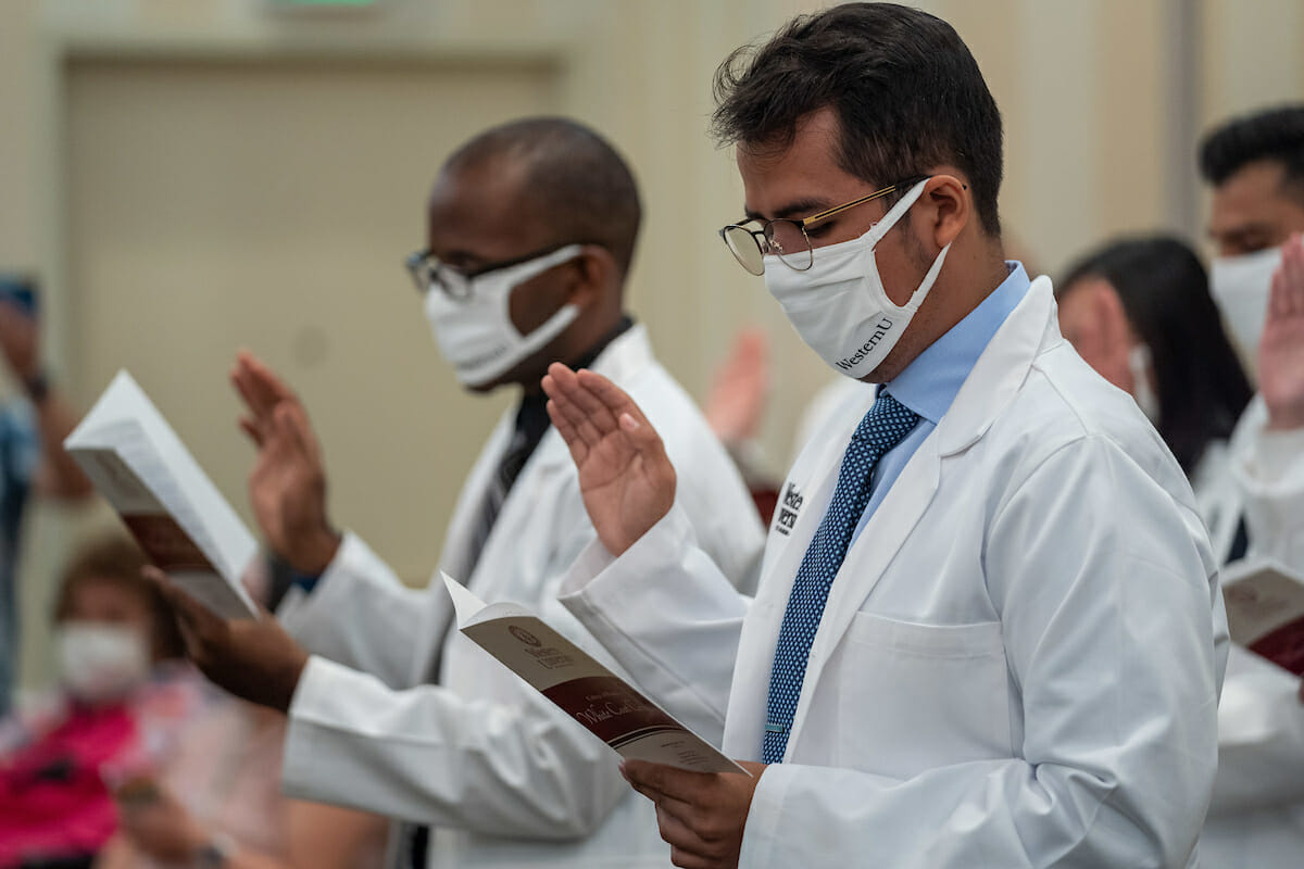 WesternU College of Pharmacy student Jesus Rottier recite's the Pharmacist's Oath during the College's White Coat Ceremony Saturday, Aug. 7, 2021 that was held at the Sheraton Fairplex in Pomona.