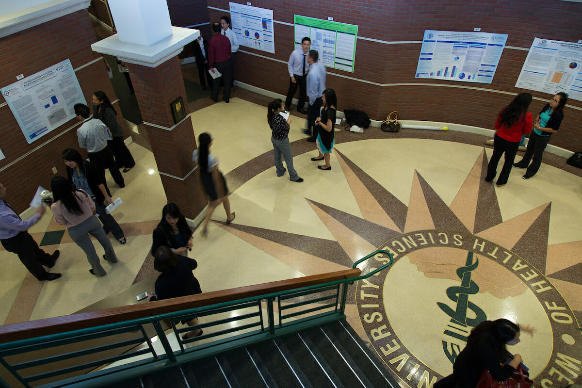 AE Poster Day, people are walking in the hall