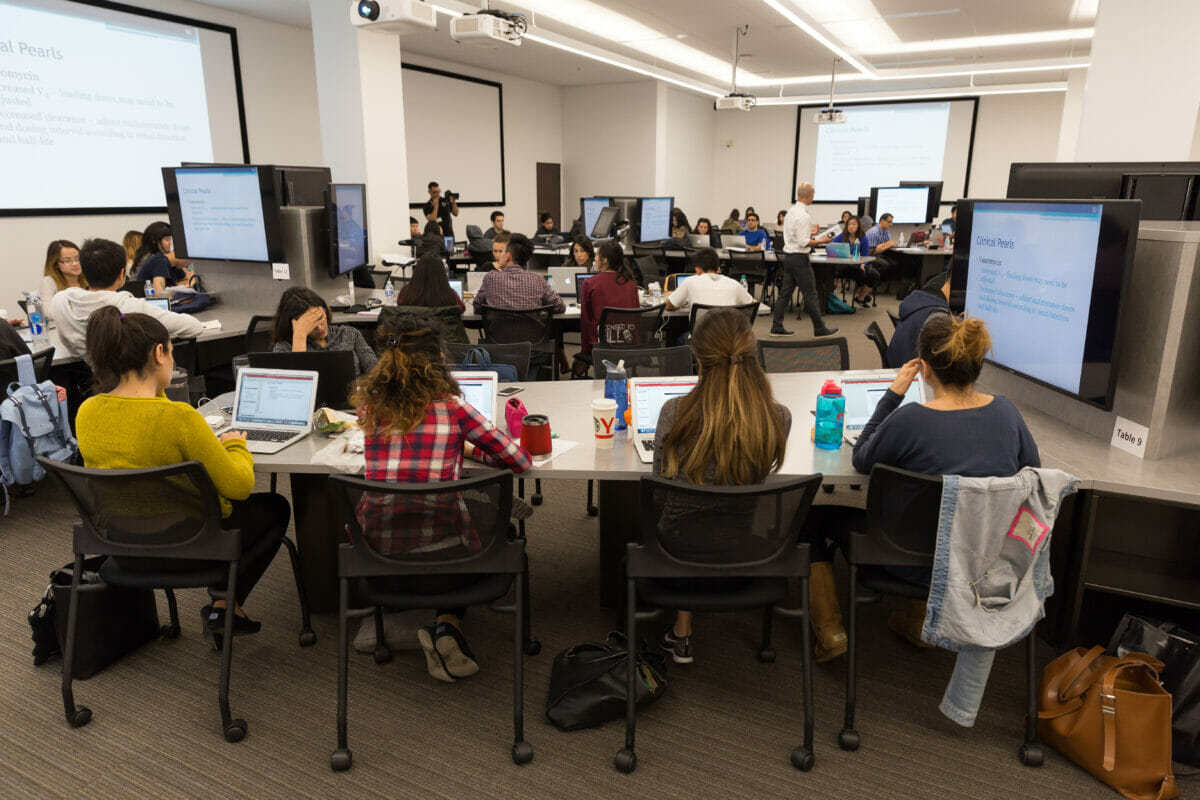 Students in classroom with large monitors at each table