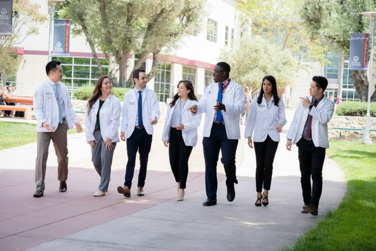 College of Pharmacy marketing photos taken in May 2019. students are walking on the campus