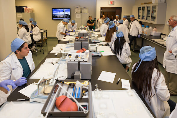 students in lab with professor at compounding lab event 2016