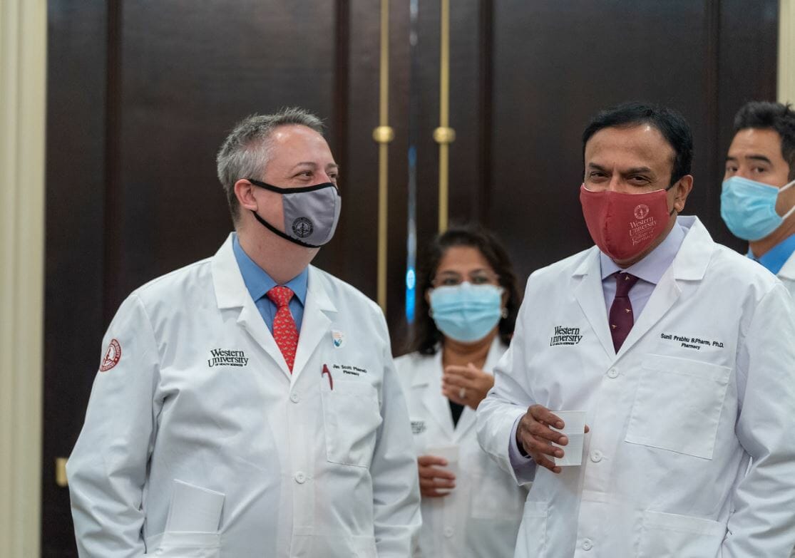 Two pharmacy faculty wearing face masks