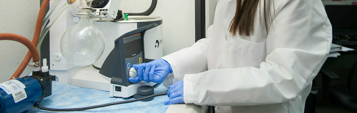 Student operating medical equipment in lab