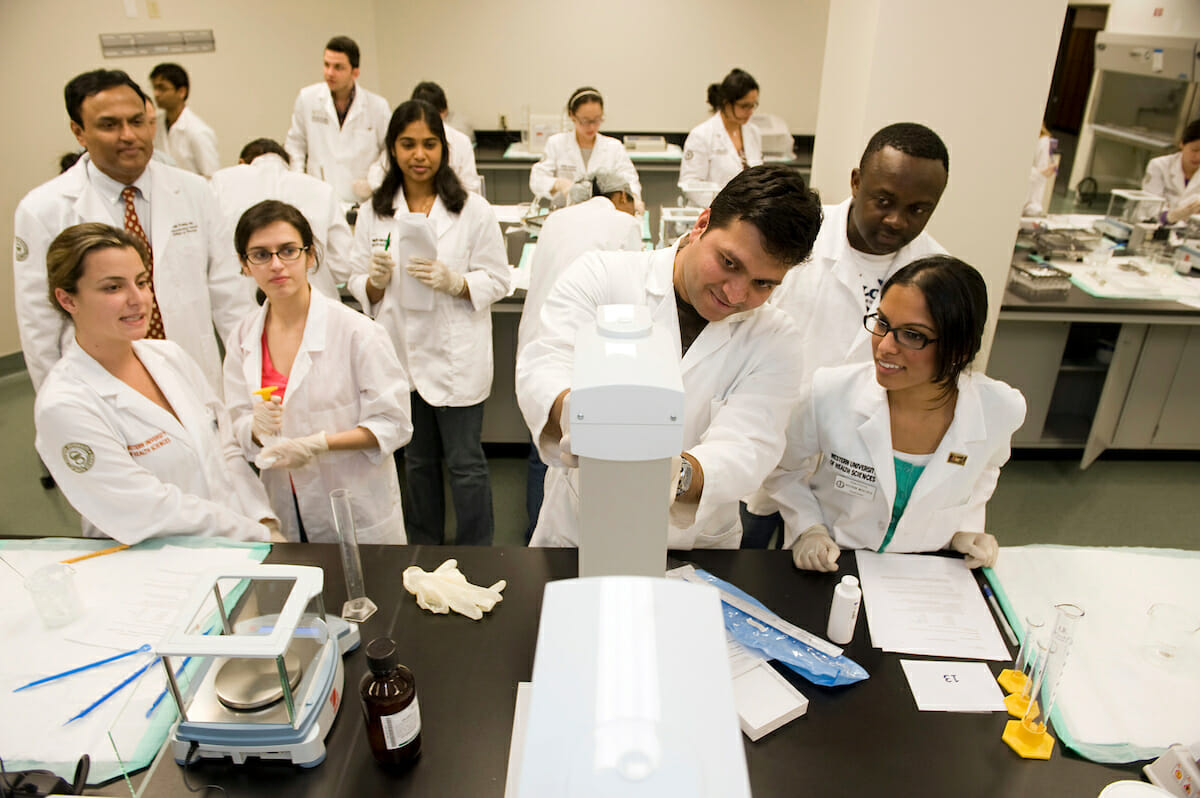 Med students in white coats in laboratory