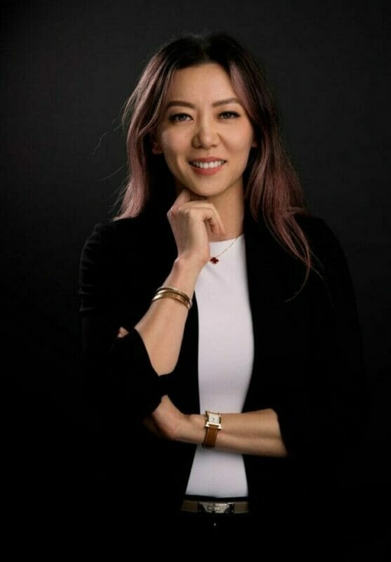 Dr. Lilia Xu, PharmD posing for a photo in a black studio.