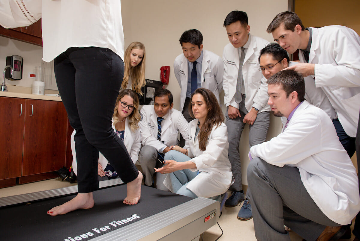 Various images for the College of Podiatric Medicice pamphlet or brochure. CPM students and Reina Deogracias, DPM, Podiatric Physician portray a foot exam and a gait analysis at the Foot & Ankle Center in the Patient Care Center.