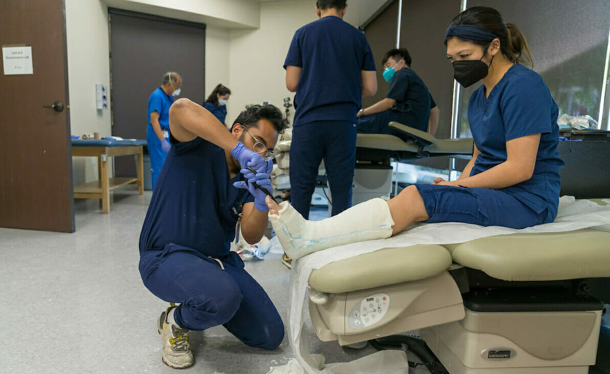 College of Podiatric Medicine Professor Stephen Wan, DPM, FACFAS, teaches third-year CPM student to be prepared for clinic. Part of that training is casting held in the Biomechanics and Gait Lab at WesternU in Pomona. Student Harsh Varshney casts Chanelle Mariano.